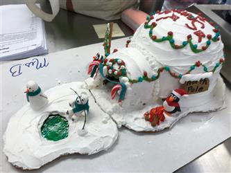 A gingerbread house made to look like its covered in snow